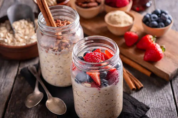 10 Quick and Healthy Breakfast Recipes to Kickstart Your Day jars of overnight oats with fresh fruit and toppings